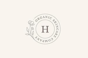 Elegant meadow flower with bud and leaves circle frame minimal line logo design template vector