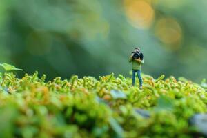 Miniature people celebrate World Photography Day with camera. photo