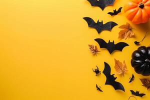 Minimalistic Halloween flat lay arrangement with bats and pumpkins on a plain white background photo