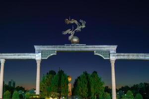 Tashkent, Uzbekistan - August 12, 2023 Memorial of Independence with illumination in the Independence Square at summertime in nighttime. photo