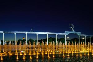 Memorial and rows of fountains with illumination in the Independence Square at summertime in nighttime, Tashkent, Uzbekistan. photo