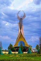UZBEKISTAN, TASHKENT - AUGUST 15, 2023 Monument of Independence in the form of a stele with a Humo bird on a twilight in the New Uzbekistan park in summer. photo