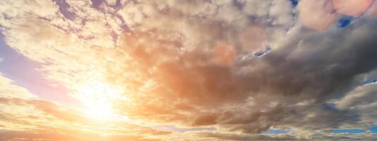 The rays of the sun breaking through the clouds in the evening or in the morning in the sunset or dawn sky. The concept of faith, hope for the best or good weather. photo