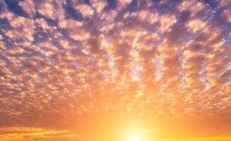 The rays of the sun breaking through the clouds in the evening or in the morning in the sunset or dawn sky. The concept of faith, hope for the best or good weather. photo