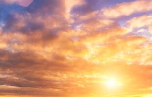 The rays of the sun breaking through the clouds in the evening or in the morning in the sunset or dawn sky. The concept of faith, hope for the best or good weather. photo