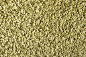 Golden texture of shiny grained metal. Abstract gold background. photo