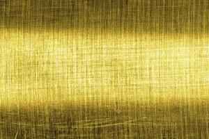 Golden texture of shiny scratched metal. Abstract gold background. photo