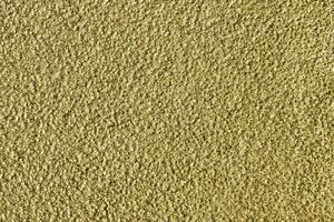 Golden texture of shiny grained metal. Abstract gold background. photo