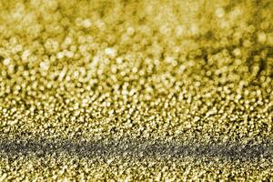 Golden texture of shiny grained metal. Abstract gold background. photo