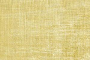 Golden texture of shiny scratched metal. Abstract gold background. photo