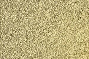 Golden texture of shiny grained metal. Abstract gold background. photo
