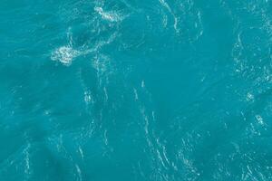 The texture of the waves of blue color of fast-flowing water in the river. photo