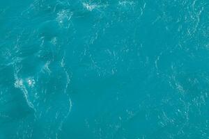 The texture of the waves of blue color of fast-flowing water in the river. photo