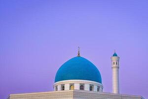 The Minor Mosque covered with white marble in the center of Tashkent at sunset. photo