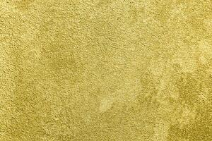 Texture of golden decorative plaster or concrete. Abstract gold grunge background. photo