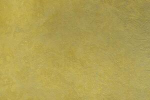 Texture of golden decorative plaster or concrete. Abstract gold grunge background. photo
