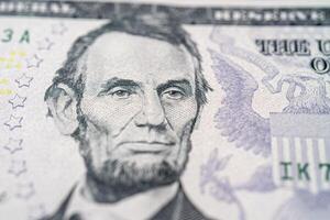 Portrait of American President Abraham Lincoln on a five dollar bill. photo