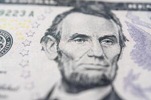 Portrait of American President Abraham Lincoln on a five dollar bill. photo