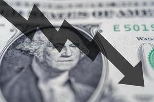 Arrow down on the background of dollar bill. The concept of inflation, depreciation of the dollar or the US economy. photo