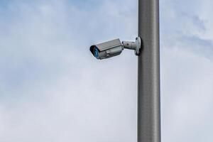 Security camera or CCTV on cloudy sky background. photo