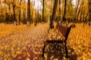 Autumn park vertical motion blurr background. Fall season abstract. photo
