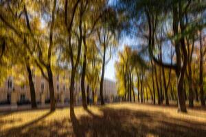 Autumn park vertical motion blurr background. Fall season abstract. photo