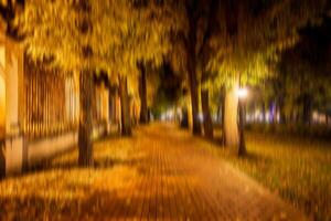 Autumn night park vertical motion blurr background. Fall season abstract. photo