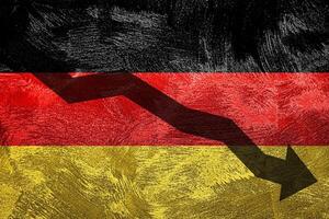 Arrow down on the background of the Germany flag. The concept of economic recession, depression and crisis. photo