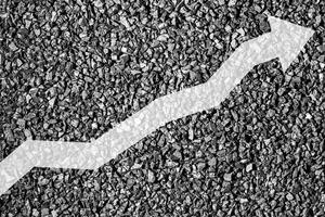 Arrow up on coal background. The concept of price growth, mining, import, export, production or sales of coal. photo