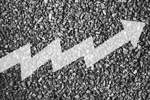 Arrow up on coal background. The concept of price growth, mining, import, export, production or sales of coal. photo