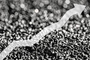 Arrow up on coal background. The concept of price growth, mining, import, export, production or sales of coal. photo