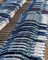 Rows of a new cars parked in a distribution center on a car factory on a sunny day. photo