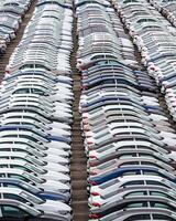 Rows of a new cars parked in a distribution center of a car factory. photo