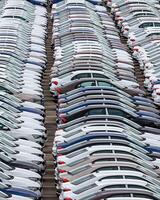 Rows of a new cars parked in a distribution center of a car factory. photo