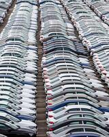 Rows of a new cars parked in a distribution center of a car factory. photo