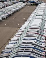 Rows of a new cars parked in a distribution center of a car factory. photo