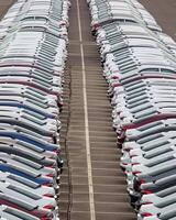 Rows of a new cars parked in a distribution center of a car factory. photo
