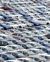 Rows of a new cars parked in a distribution center of a car factory. photo