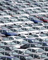 Rows of a new cars parked in a distribution center of a car factory. photo
