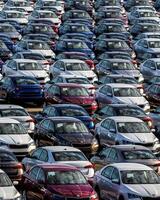 Volkswagen Group Rus, Russia, Kaluga - MAY 25, 2020 Rows of a new cars parked in a distribution center on a sunny day in the sprin. photo