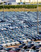 Volkswagen Group Rus, Russia, Kaluga - MAY 25, 2020 Rows of a new cars parked in a distribution center on a sunny day in the spring photo