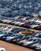 Volkswagen Group Rus, Russia, Kaluga - MAY 25, 2020 Rows of a new cars parked in a distribution center on a sunny day in the spring photo
