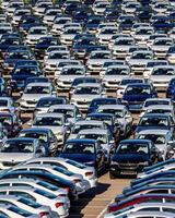 Volkswagen Group Rus, Russia, Kaluga - MAY 25, 2020 Rows of a new cars parked in a distribution center on a sunny day in the spring photo