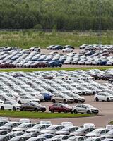 Volkswagen Group Rus, Russia, Kaluga - MAY 24, 2020 Rows of a new cars parked in a distribution center on a cloudy day in the spring, a car factory photo