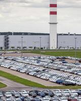 Volkswagen Group Rus, Russia, Kaluga - MAY 24, 2020 Rows of a new cars parked in a distribution center on a cloudy day in the spring, a car factory photo
