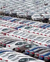 Volkswagen Group Rus, Russia, Kaluga - MAY 24, 2020 Rows of a new cars parked in a distribution center on a cloudy day in the spring, a car factory photo