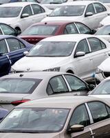 Volkswagen Group Rus, Russia, Kaluga - MAY 24, 2020 Rows of a new cars parked in a distribution center on a cloudy day in the spring, a car factory photo