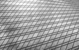 Fragment of a modern office building. Abstract geometric background. Part of a skyscraper with glass windows. Black and white. photo