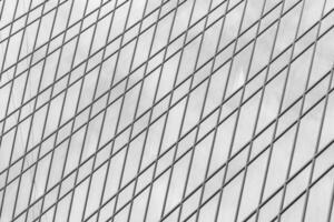 Fragment of a modern office building. Abstract geometric background. Part of a skyscraper with glass windows. Black and white. photo