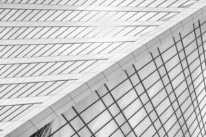 Fragment of a modern office building. Abstract geometric background. Part of a skyscraper with glass windows. Black and white. photo